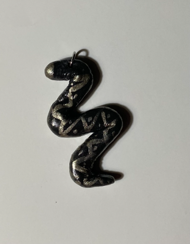 Dije SERPENT negro y dorado