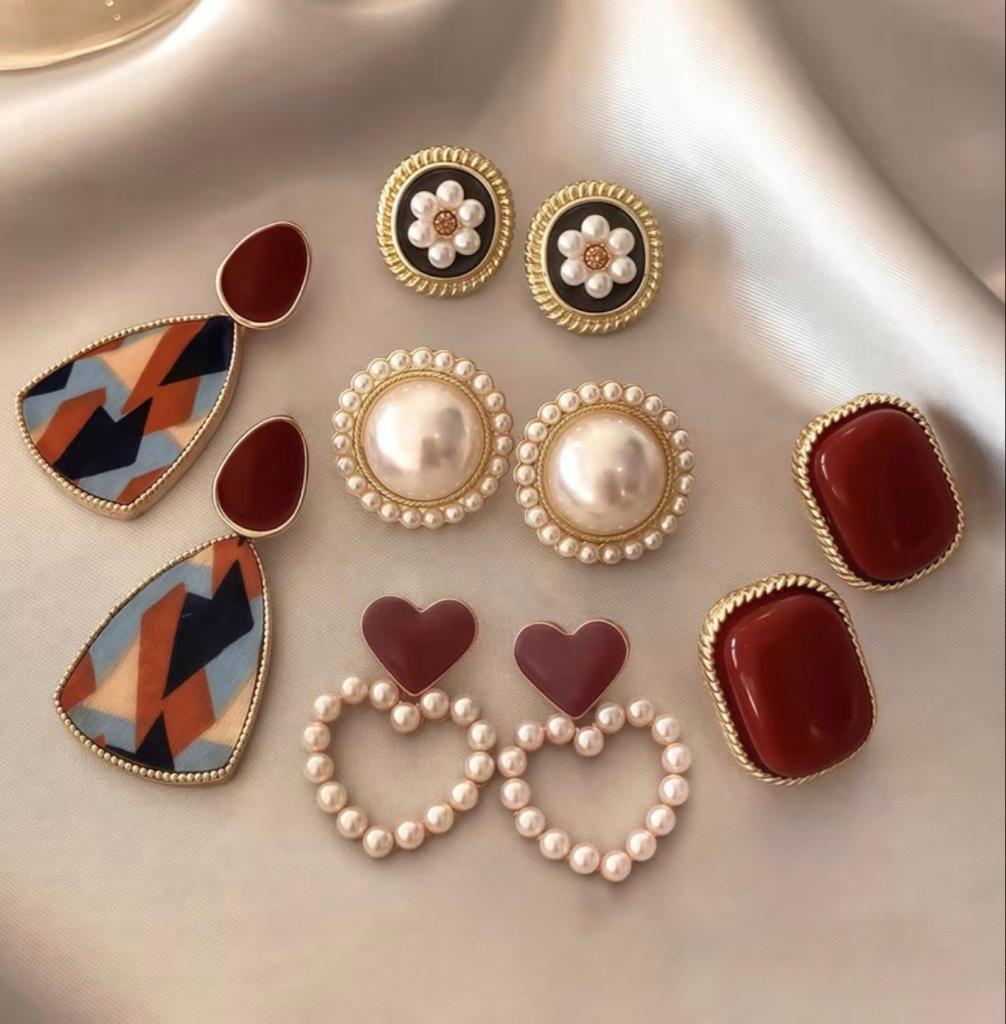 Aretes variados tonos Vino y perlas