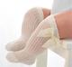 Calcetines altos beige calados con lazo talla S